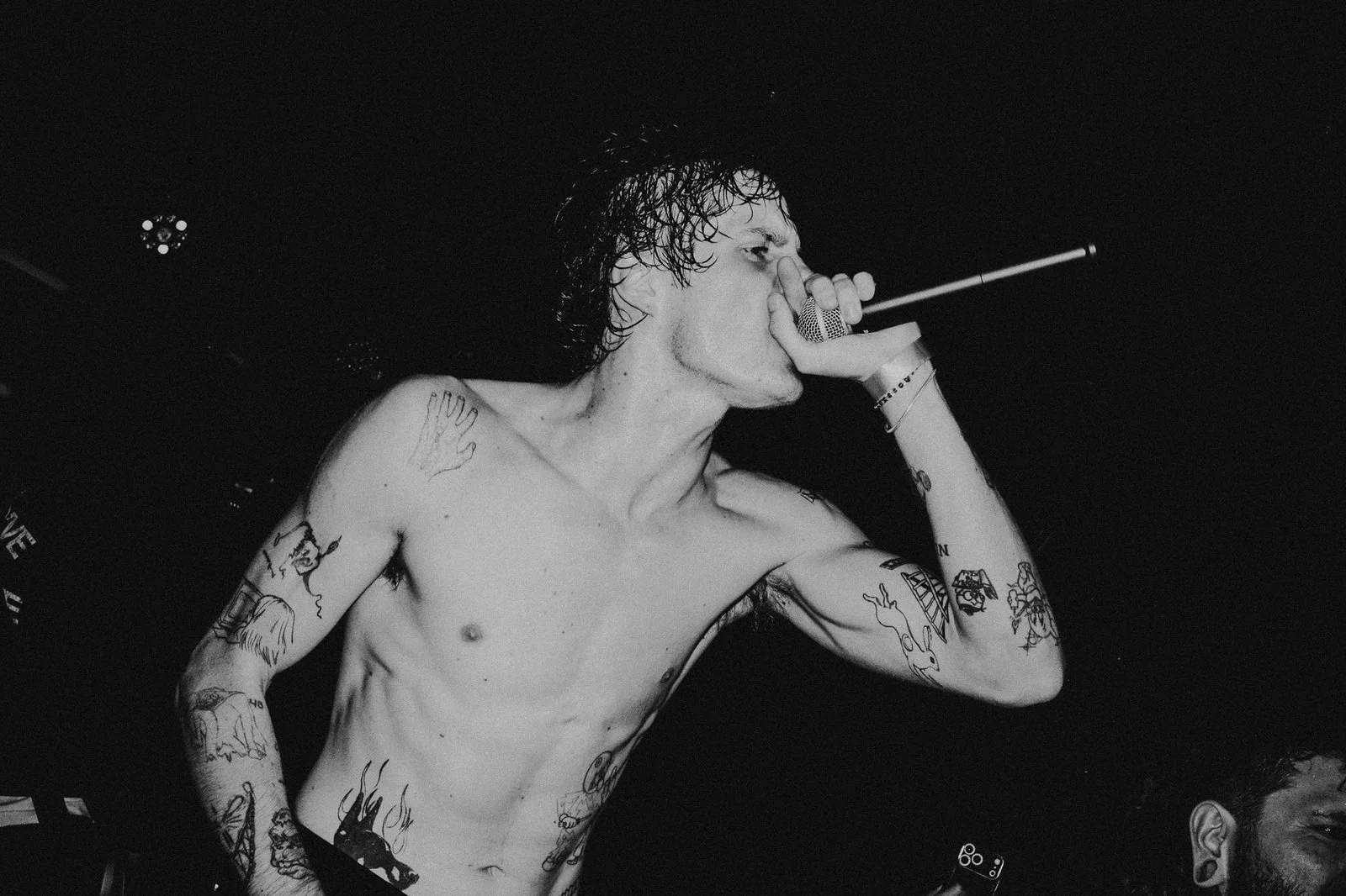 Private School's frontman screams into the mic, in black and white.